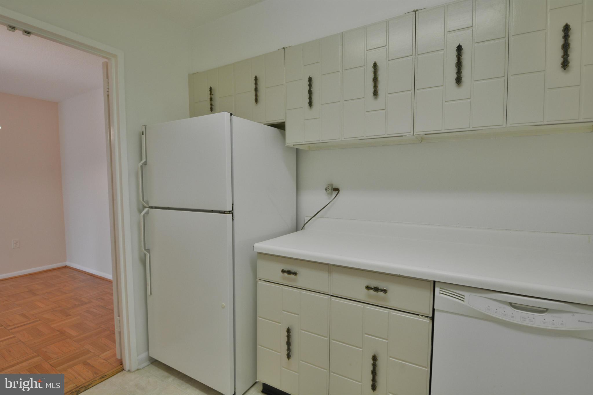 700 7th Street Southwest, Unit 630 Washington, DC 20024 - Photo 12 of 28 a kitchen with cabinets and a refrigerator
