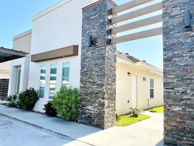 a front view of a house with a garden