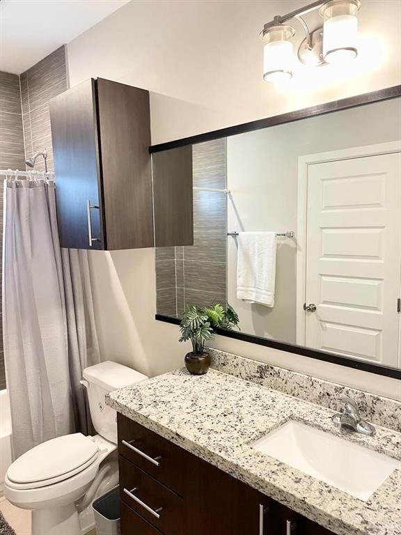 3007 Javalina Avenue, Unit 4 Edinburg, TX 78542 - Photo 12 of 16 a bathroom with a granite countertop sink and a mirror