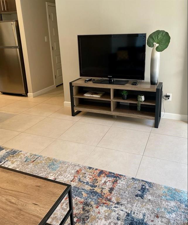 3007 Javalina Avenue, Unit 4 Edinburg, TX 78542 - Photo 5 of 16 a living room with furniture and a flat screen tv