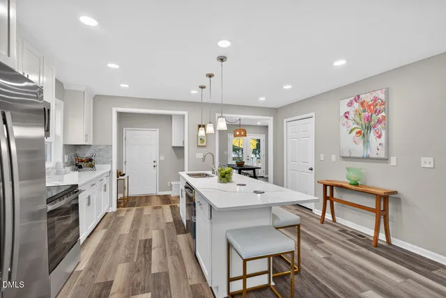 a large kitchen with a table and chairs