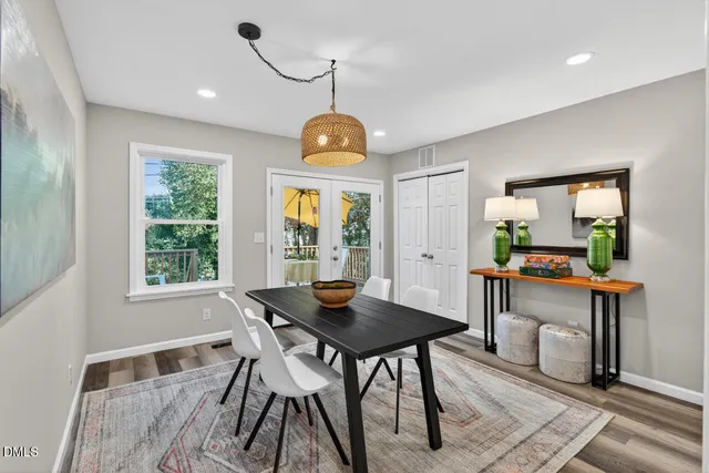 a view of a dining room with furniture wooden floor and a chandelier