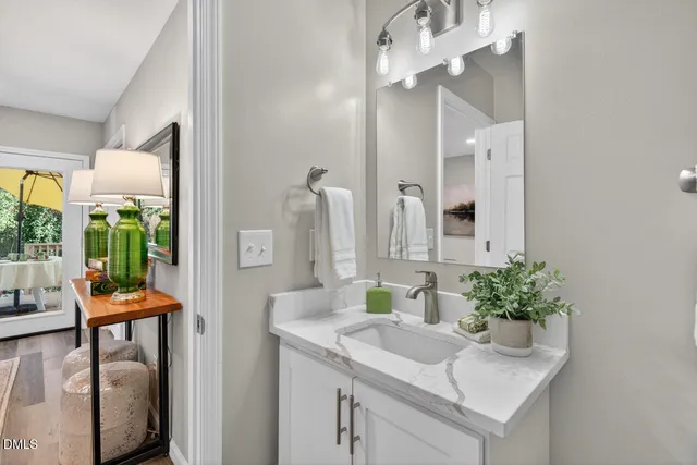 a bathroom with a granite countertop sink mirror and toilet