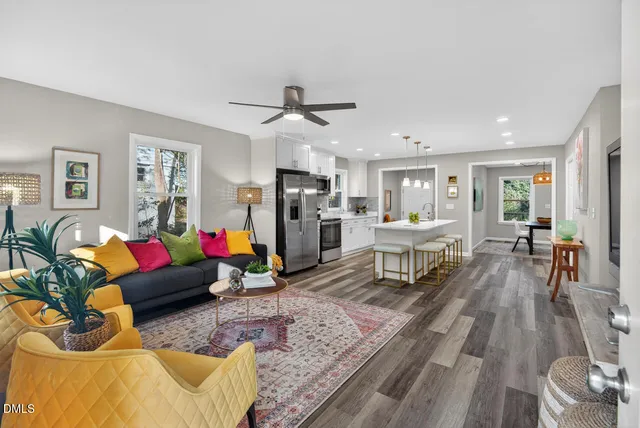 a living room with furniture and wooden floor