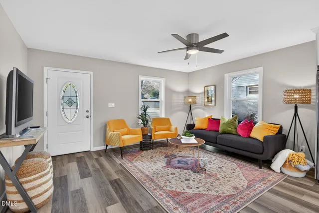 a living room with furniture and wooden floor