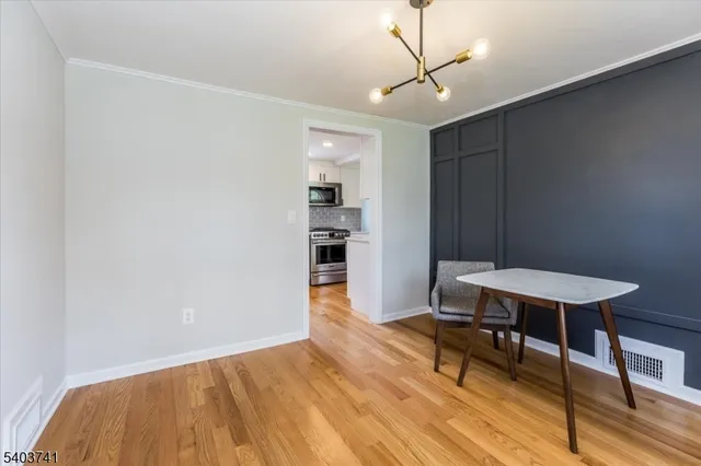 a workspace with wooden floor and a bookshelf
