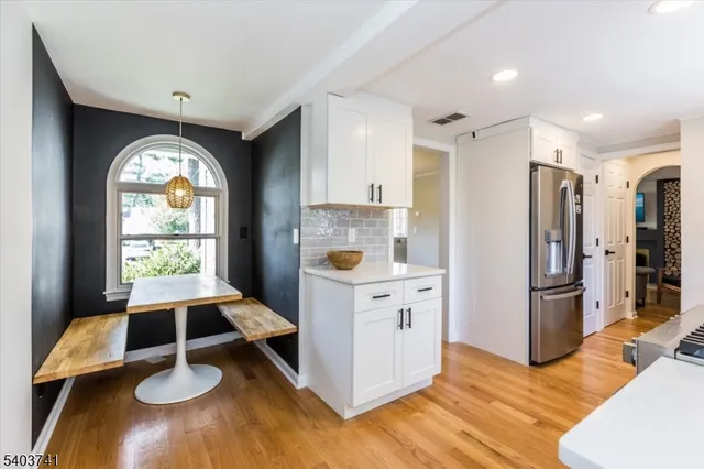 a kitchen with kitchen island wooden floor and window