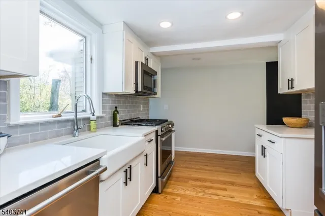 a kitchen with a sink stove and cabinets