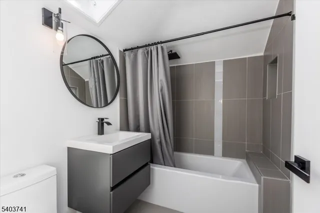 a bathroom with a sink a toilet and a mirror