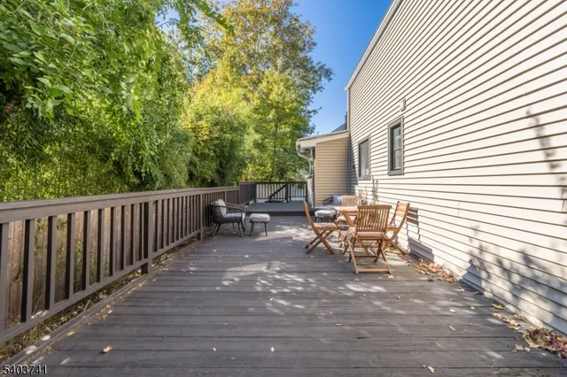 a view of a patio with table and chairs and wooden floor