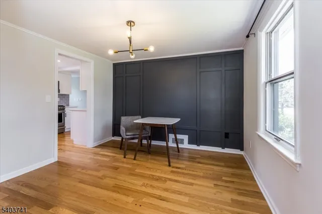 a view of a livingroom with furniture window and wooden floor