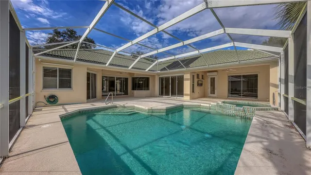 a swimming pool with patio outdoor seating and yard