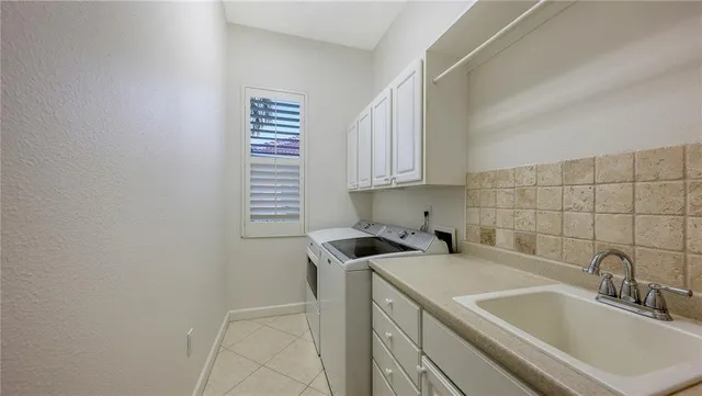 a kitchen with a sink cabinets and utility