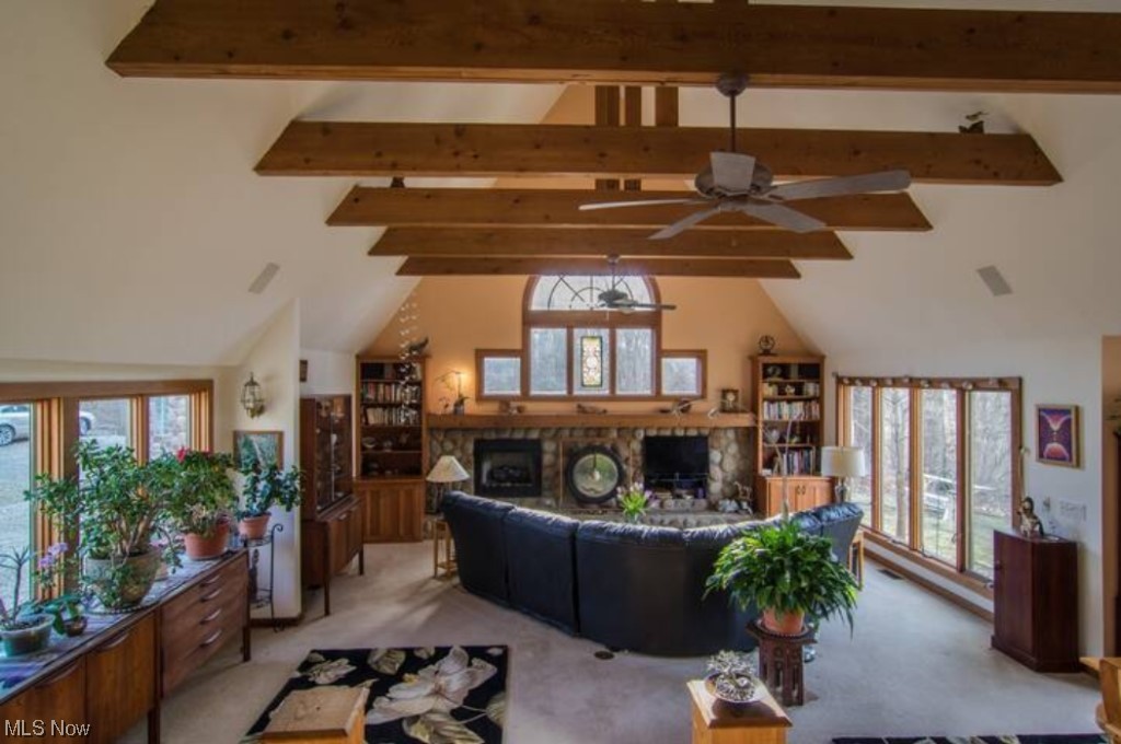 41678 Butternut Ridge Road Elyria, OH 44035 - Photo 2 of 25 Carpeted living room with beam ceiling, high vaulted ceiling, and ceiling fan