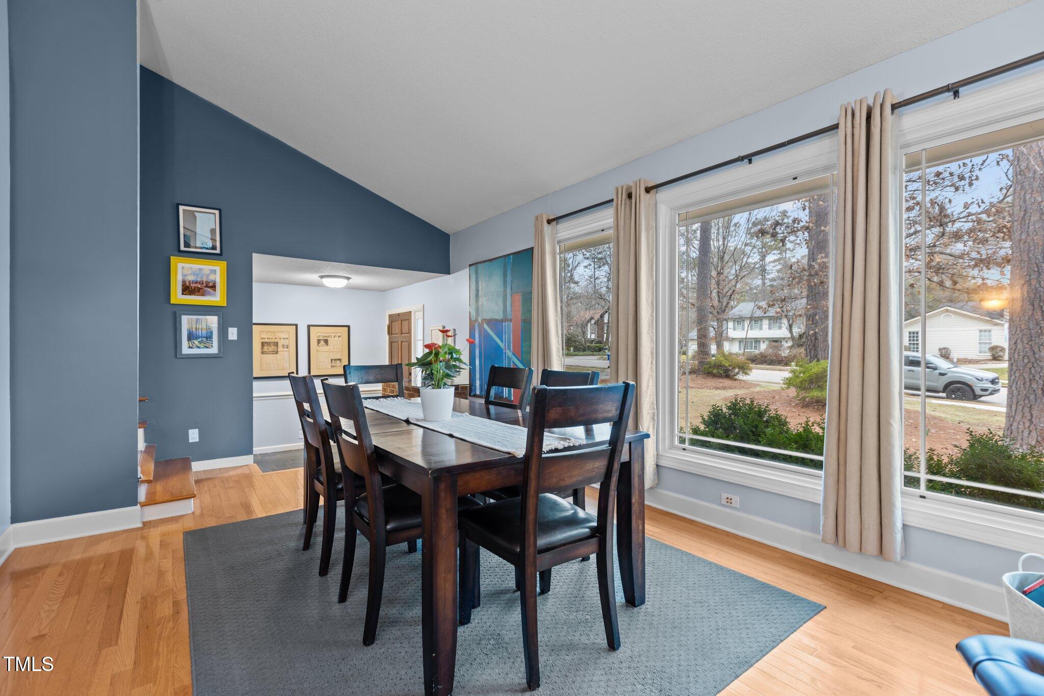 7612 Harps Mill Road Raleigh, NC 27615 - Photo 9 of 49 a view of a dining room with furniture and wooden floor