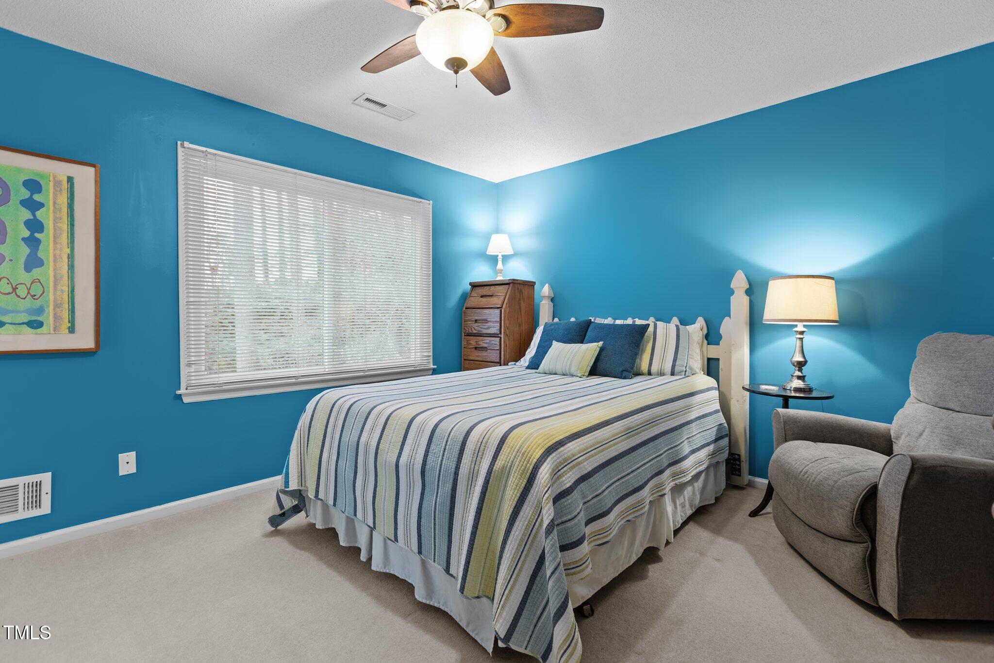 7612 Harps Mill Road Raleigh, NC 27615 - Photo 23 of 49 a bedroom with a bed and window
