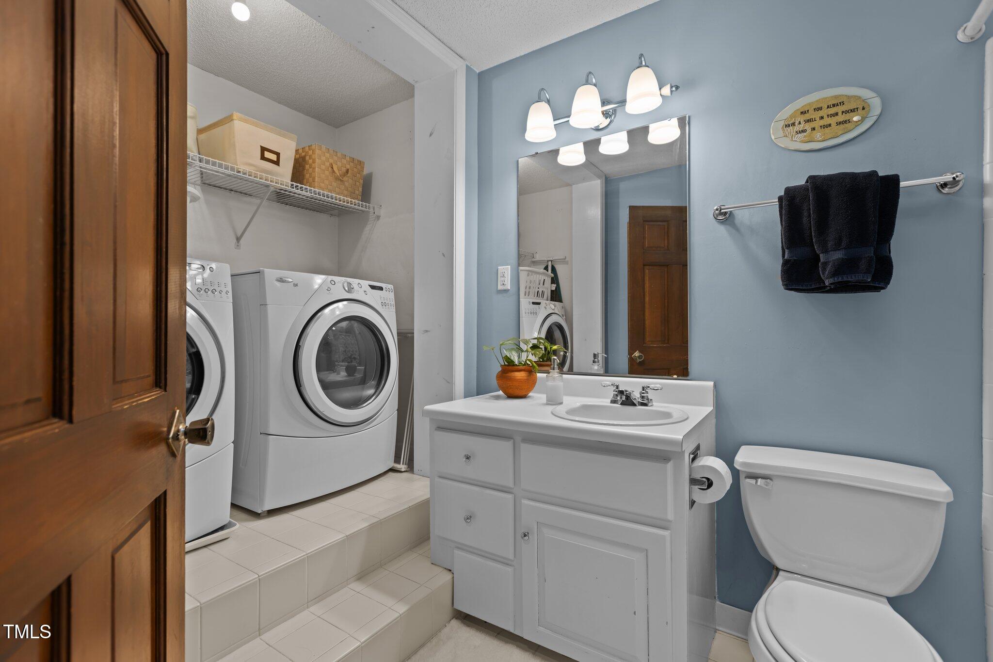 7612 Harps Mill Road Raleigh, NC 27615 - Photo 33 of 49 a bathroom with a toilet a sink and a mirror