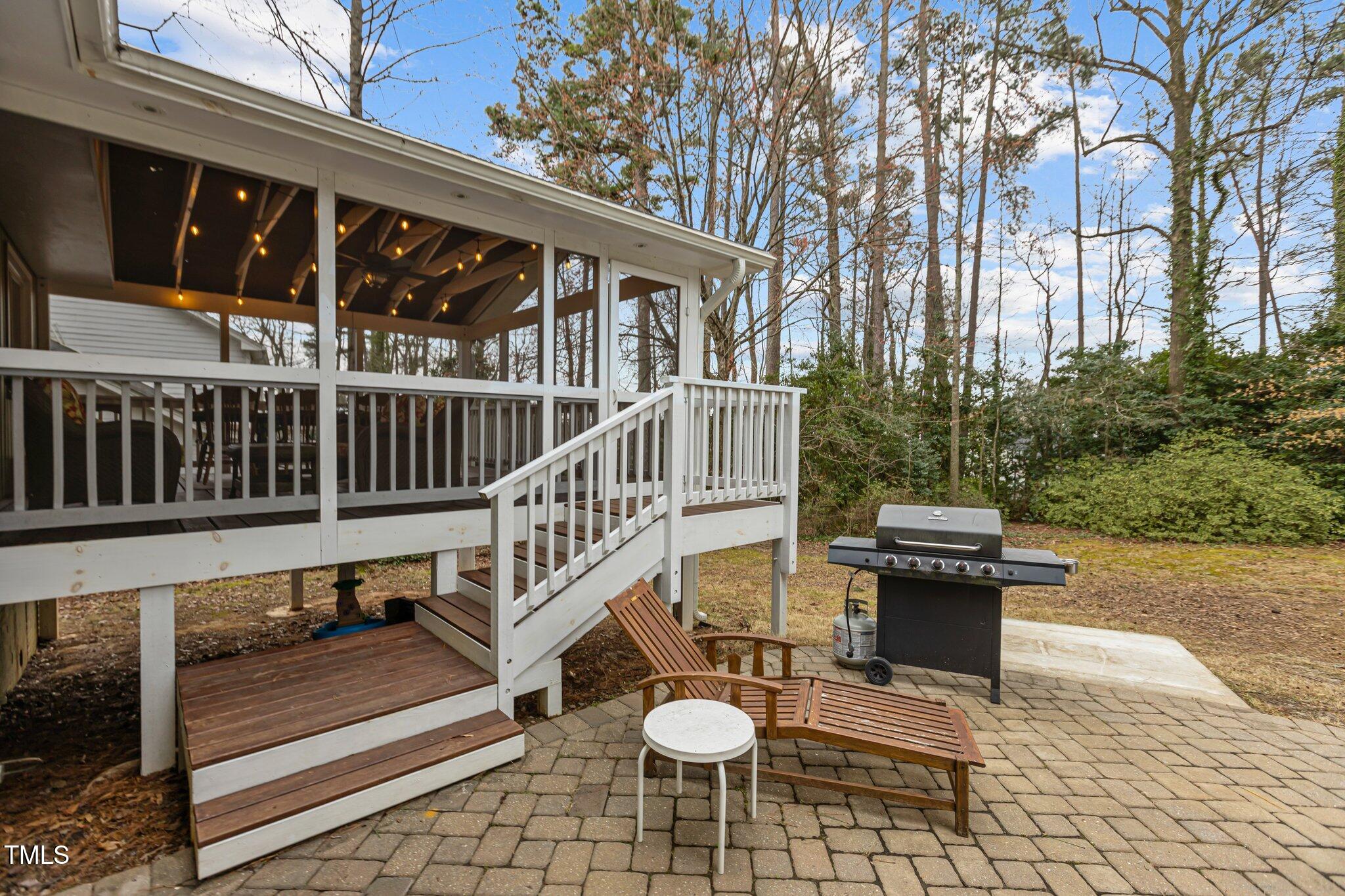 7612 Harps Mill Road Raleigh, NC 27615 - Photo 37 of 49 a view of a chair and tables in the patio
