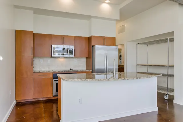 a kitchen with a sink cabinets and wooden floor