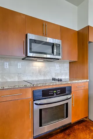 a stove top oven sitting inside of a kitchen