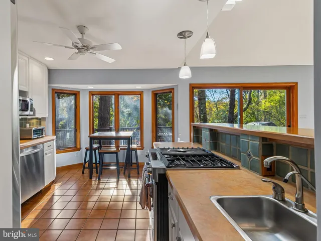a kitchen with stainless steel appliances a sink cabinets and a refrigerator