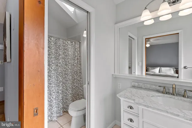 a spacious bedroom with a bed and a fireplace