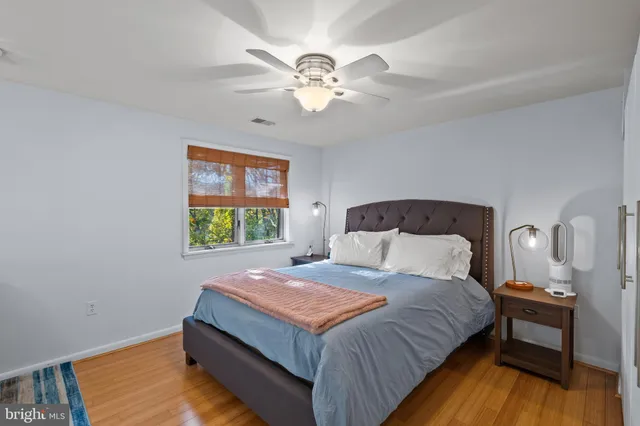 a bathroom with a granite countertop sink a toilet and a mirror