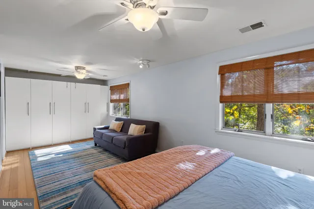 a bedroom with a bed couch and window