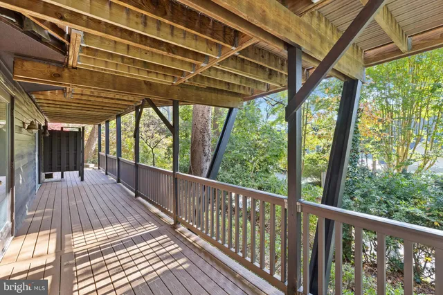 a bedroom with a balcony a bed and a window