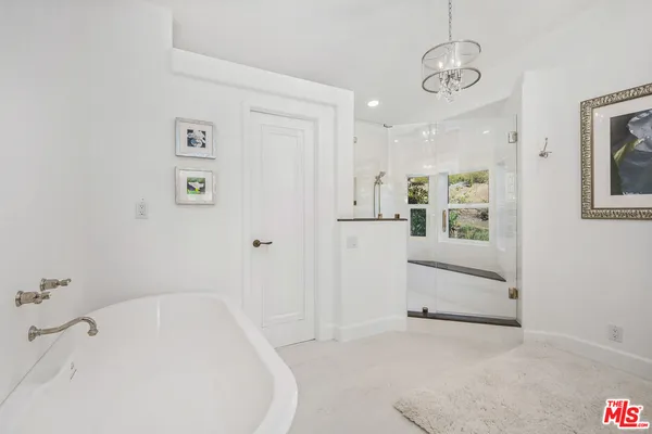 a bathroom with a bathtub and shower