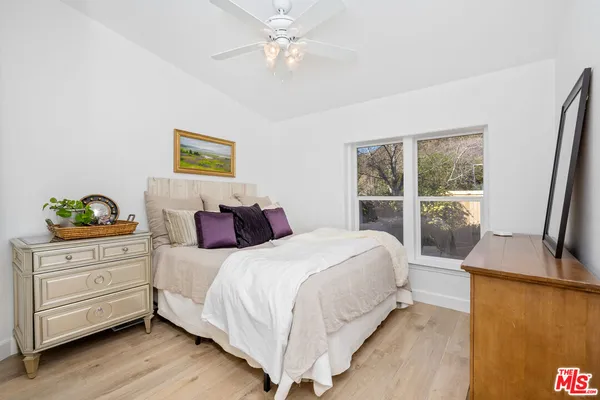a bedroom with a large bed and a window