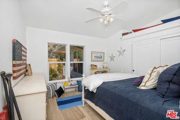 a bedroom with a bed dresser and a window