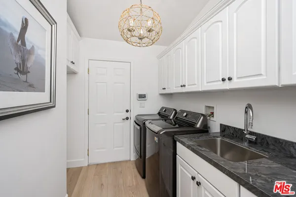 a kitchen with granite countertop a sink a stove and cabinets