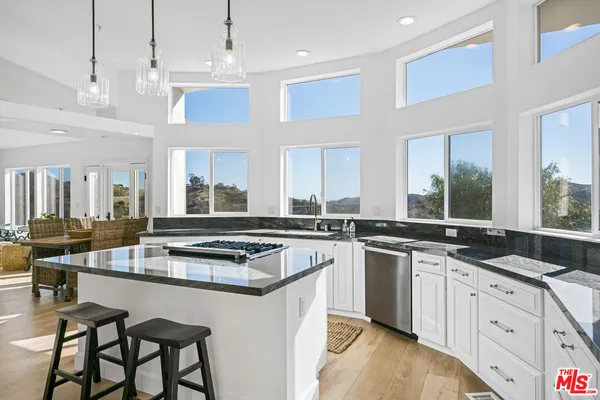 a kitchen with a stove a sink and a refrigerator