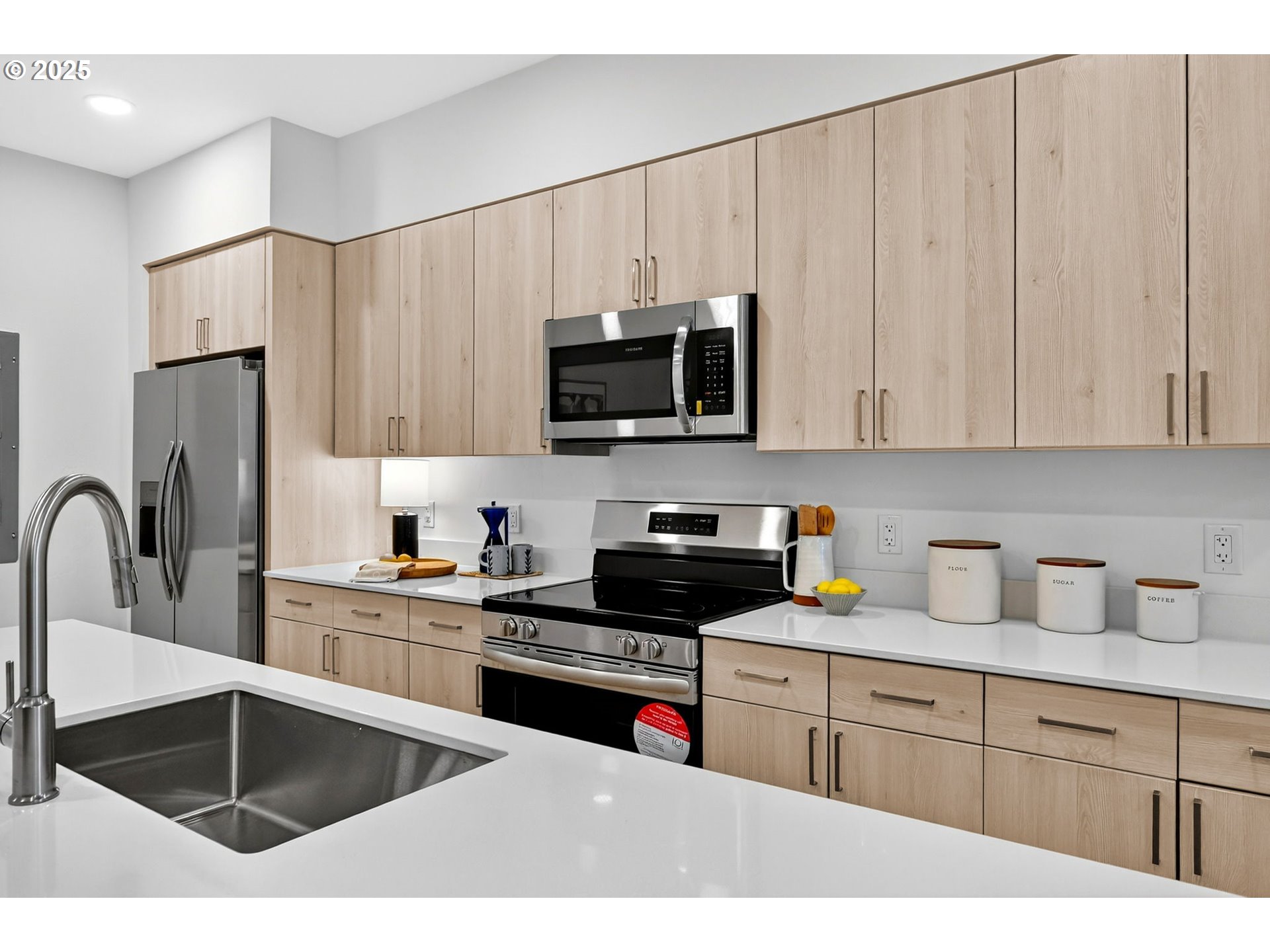 7248 Northeast Going Street Portland, OR 97218 - Photo 11 of 31 a kitchen with stainless steel appliances kitchen island granite countertop a refrigerator sink and cabinets