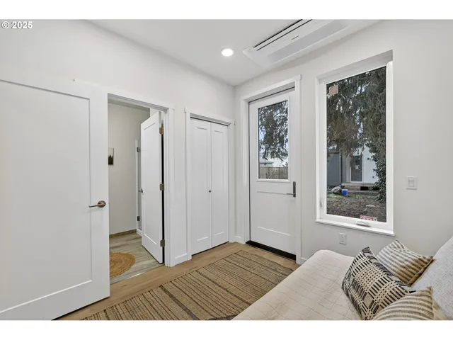 a view of bedroom with wooden floor and window