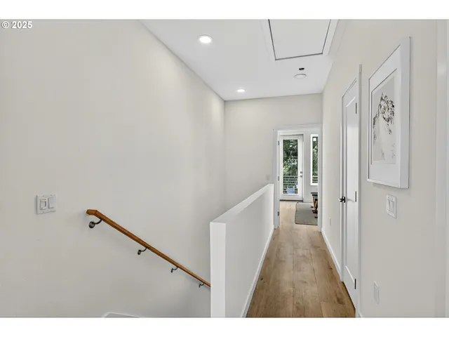 a view of a hallway with wooden floor