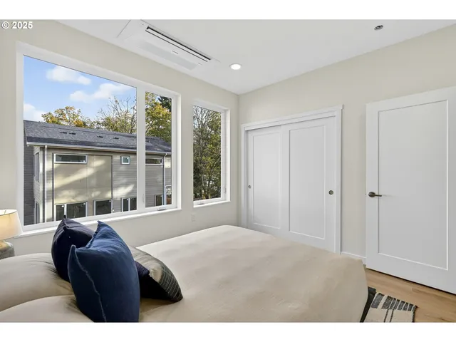 a bedroom with a large bed and a large window