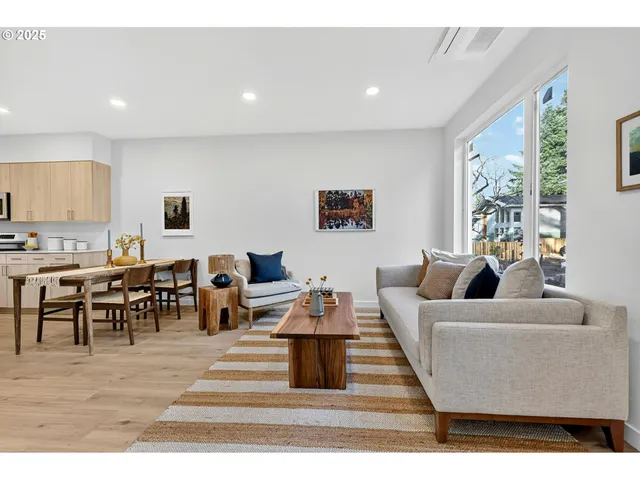 a living room with furniture kitchen view and a dining table