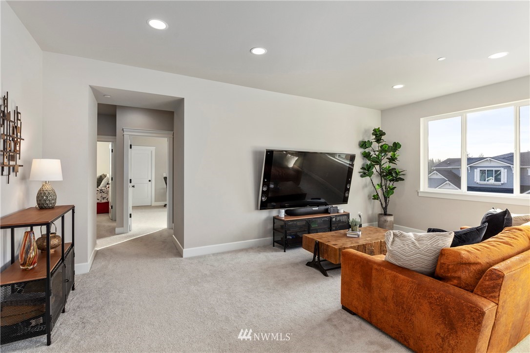 35 242nd Street Southeast Bothell, WA 98021 - Photo 18 of 29 a living room with furniture and a flat screen tv