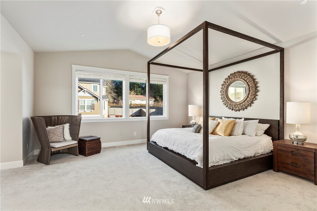 35 242nd Street Southeast Bothell, WA 98021 - Photo 20 of 29 a bed room with a bed and a chandelier