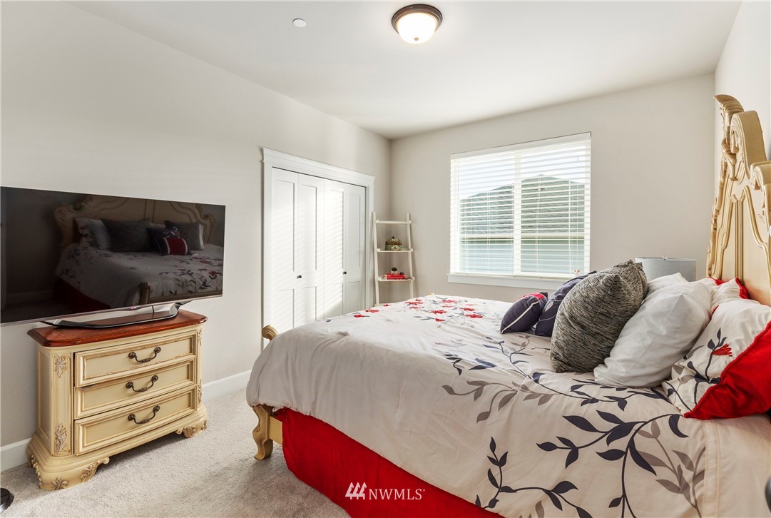 35 242nd Street Southeast Bothell, WA 98021 - Photo 24 of 29 a bedroom with a bed and flat screen tv