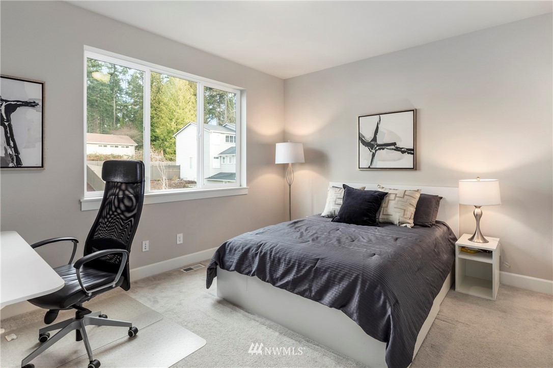 35 242nd Street Southeast Bothell, WA 98021 - Photo 25 of 29 a bedroom with a bed a desk and chair with window