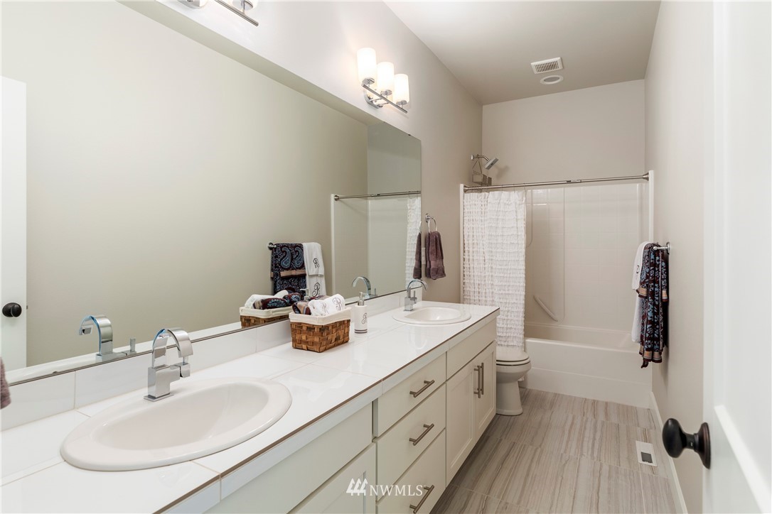 35 242nd Street Southeast Bothell, WA 98021 - Photo 26 of 29 a bathroom with a double vanity sink a mirror and shower