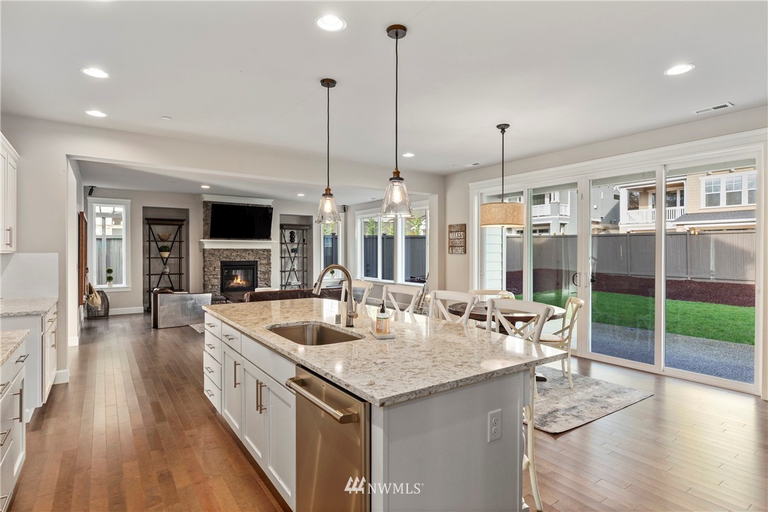 35 242nd Street Southeast Bothell, WA 98021 - Photo 6 of 29 a open kitchen with stainless steel appliances granite countertop a sink and a wooden floor