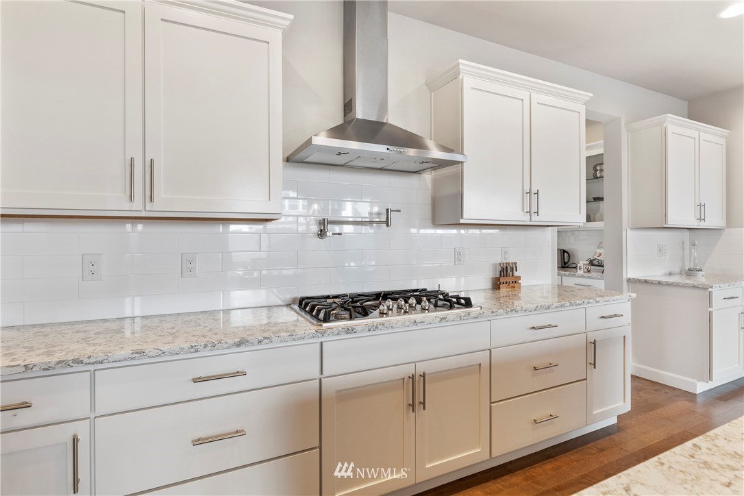 35 242nd Street Southeast Bothell, WA 98021 - Photo 8 of 29 a kitchen with stainless steel appliances granite countertop a sink a stove and cabinets