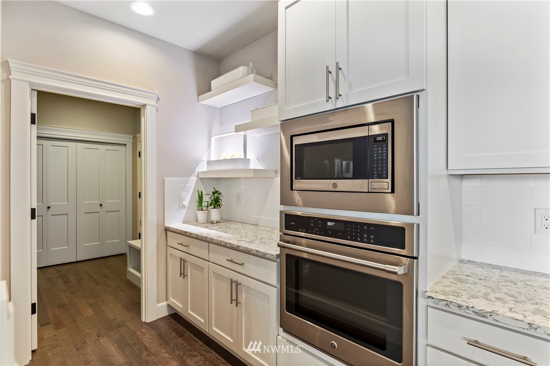 35 242nd Street Southeast Bothell, WA 98021 - Photo 10 of 29 a kitchen with white cabinets and stainless steel appliances