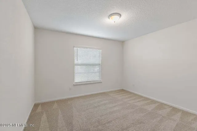 an empty room with a empty space and a window