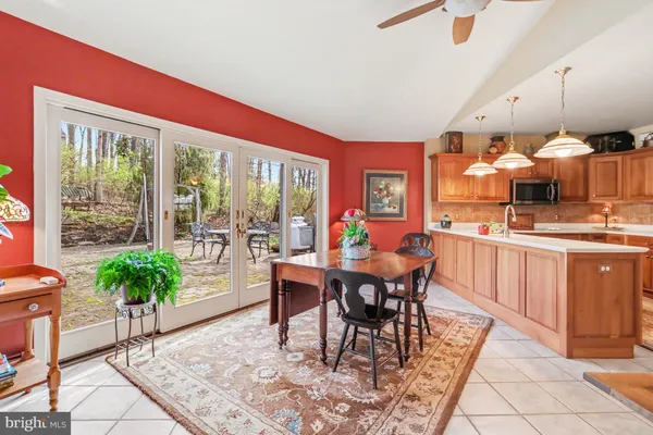 a dining room filled with furniture and wooden floor