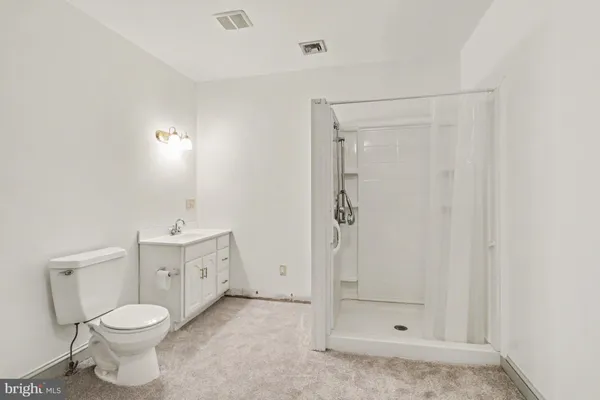 a bathroom with a toilet sink and shower